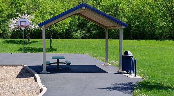 A shade structure, and basketball hoop at Finch park